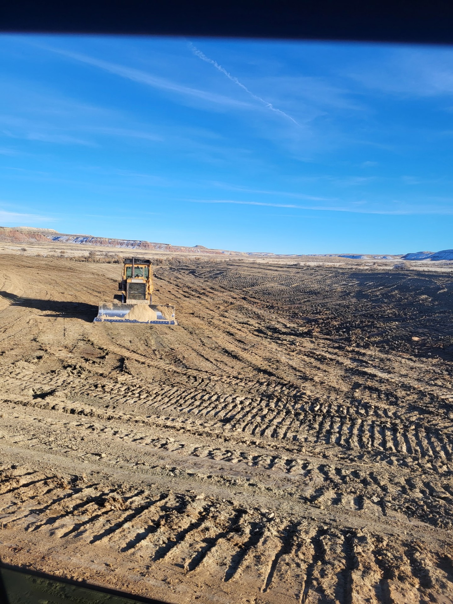 Dozer working dirt and building a pad in the Wyoming high desert