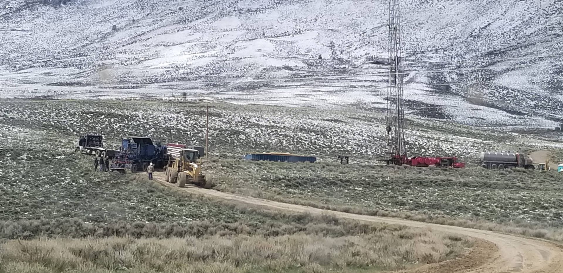Motor grader maintaining lease road at a Wyoming drilling rig